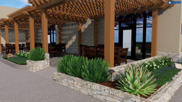 An outdoor seating area in Baton Rouge features wooden pergolas offering shade over dark wooden tables and chairs. Stone planters with green shrubs and plants line the perimeter, showcasing thoughtful landscape design. In the background, large glass doors contrast with a light terracotta wall.