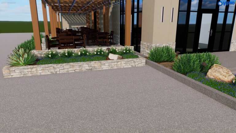 Outdoor dining area with wooden tables and chairs under a pergola attached to a building with stone base and beige walls. The landscape design includes stone planters with shrubs, flowers, rocks, and accent lighting. In the background of this meticulously planned space in Baton Rouge, you'll see a clear sky and open space.
